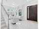 Bright foyer featuring a modern staircase, tile flooring, and a front door at 1675 Amsel Falls Park Ter, Winter Garden, FL 34787