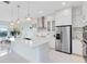 Bright, modern kitchen features stainless steel appliances, a large island, and pendant lighting at 1675 Amsel Falls Park Ter, Winter Garden, FL 34787