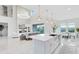 Bright kitchen with white cabinets, a large island, stainless steel appliances, and a view of the living area at 1675 Amsel Falls Park Ter, Winter Garden, FL 34787