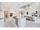 Open kitchen featuring white cabinets, stainless steel appliances, an island, and a view of the living room at 1675 Amsel Falls Park Ter, Winter Garden, FL 34787