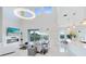 Open living room with fireplace, TV, white tile floors, and sliding glass doors to the backyard at 1675 Amsel Falls Park Ter, Winter Garden, FL 34787