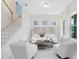 Bright Living Room with white furniture, tile floors, staircase, and modern design at 1675 Amsel Falls Park Ter, Winter Garden, FL 34787