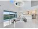 Open living room with fireplace, TV, white tile floors, and sliding glass doors to the backyard at 1675 Amsel Falls Park Ter, Winter Garden, FL 34787