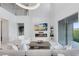 Open living room with fireplace, TV, white tile floors, and sliding glass doors to the backyard at 1675 Amsel Falls Park Ter, Winter Garden, FL 34787