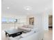 Cozy loft area with a white sofa and views of the outside from the large window at 1675 Amsel Falls Park Ter, Winter Garden, FL 34787