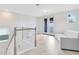 Well-lit loft with hardwood floors, balcony access and modern furnishings in a neutral color palette at 1675 Amsel Falls Park Ter, Winter Garden, FL 34787