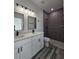 Modern bathroom with a dual sink vanity, sleek fixtures, and a walk-in shower at 17167 Sw 40 Ter, Ocala, FL 34473