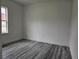 Bright bedroom with luxury vinyl flooring and a large window at 17167 Sw 40 Ter, Ocala, FL 34473