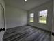 Bright bedroom with two windows offering natural light and wood-look flooring at 17167 Sw 40 Ter, Ocala, FL 34473