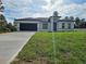 Charming single-story home with a dark two car garage and a large front yard at 17167 Sw 40 Ter, Ocala, FL 34473