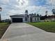 Charming single-story home with a dark two car garage and a long concrete driveway at 17167 Sw 40 Ter, Ocala, FL 34473