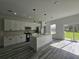 Modern kitchen featuring white cabinets, stainless steel appliances, and a large central island at 17167 Sw 40 Ter, Ocala, FL 34473