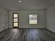 Open living room featuring wood-look flooring, a modern wood door, and a view of the outdoors at 17167 Sw 40 Ter, Ocala, FL 34473