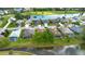 Aerial view of homes with lake and golf course, showcasing community amenities at 1842 Turnbull Lakes Dr, New Smyrna Beach, FL 32168