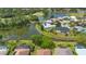 Scenic aerial view of waterfront homes in a golf course community featuring lush greenery and mature trees at 1842 Turnbull Lakes Dr, New Smyrna Beach, FL 32168