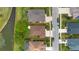 Aerial view of a single Gathering home featuring a well maintained yard, screened in pool, and mature landscaping at 1842 Turnbull Lakes Dr, New Smyrna Beach, FL 32168