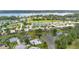 Beautiful aerial view of a waterfront community with lush landscaping, golf course, and access to a large lake at 1842 Turnbull Lakes Dr, New Smyrna Beach, FL 32168