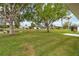 Scenic backyard with a pond view, mature trees, and well-kept lawn at 1842 Turnbull Lakes Dr, New Smyrna Beach, FL 32168