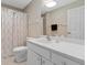 Bathroom featuring a white vanity with a shower and bathtub combo with a neutral color palette at 1842 Turnbull Lakes Dr, New Smyrna Beach, FL 32168