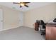 Bright bedroom featuring neutral carpet, ceiling fan, and a large window offering pleasant views at 1842 Turnbull Lakes Dr, New Smyrna Beach, FL 32168