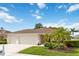 Single story home with a well-manicured lawn and 2 car garage showcasing its curb appeal at 1842 Turnbull Lakes Dr, New Smyrna Beach, FL 32168