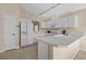 Well-lit kitchen with white cabinetry, tile flooring, breakfast bar, and modern appliances, offering a clean and functional space at 1842 Turnbull Lakes Dr, New Smyrna Beach, FL 32168