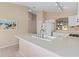 Bright kitchen featuring a modern faucet and appliances at 1842 Turnbull Lakes Dr, New Smyrna Beach, FL 32168