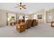 Open-concept living room with neutral tones, vaulted ceilings, and well-placed lighting at 1842 Turnbull Lakes Dr, New Smyrna Beach, FL 32168