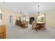 Spacious living room featuring neutral carpeting, ceiling fan, and natural light from sliding glass doors at 1842 Turnbull Lakes Dr, New Smyrna Beach, FL 32168
