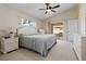 Spacious bedroom with a ceiling fan, neutral carpet, and a sliding glass door to the outdoor area at 1842 Turnbull Lakes Dr, New Smyrna Beach, FL 32168