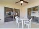 Covered patio features overhead fan, table and chairs, and screened windows at 1842 Turnbull Lakes Dr, New Smyrna Beach, FL 32168