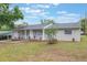 Charming home featuring a well-manicured front yard with beautiful plants and a driveway at 2113 Winnetka Ct, Orlando, FL 32818