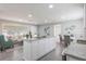 Open kitchen with granite countertops overlooks a living area and round dining table with gray chairs at 2113 Winnetka Ct, Orlando, FL 32818