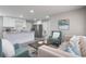 Open-concept living room with luxury flooring, flowing into the kitchen, and comfortable modern furniture at 2113 Winnetka Ct, Orlando, FL 32818