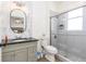 Modern bathroom featuring a glass-enclosed shower, stylish vanity, and elegant mirror at 217 Herring St, Davenport, FL 33897