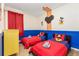 bedroom featuring themed decor, with red bedding and playful cartoon character wall art at 217 Herring St, Davenport, FL 33897