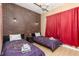 Unique bedroom with a brick accent wall, twin beds, and fun decor at 217 Herring St, Davenport, FL 33897