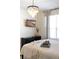 Serene bedroom with a chandelier, TV, and plush bedding creating a calming retreat at 217 Herring St, Davenport, FL 33897