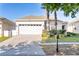 Charming single-story home with a two-car garage, well-manicured lawn, and a brick-paved driveway at 217 Herring St, Davenport, FL 33897