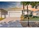 Charming single-story home with a two-car garage, well-manicured lawn, and a brick-paved driveway at 217 Herring St, Davenport, FL 33897