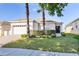 Well-maintained single-story home with lush lawn, a two-car garage, and mature landscaping at 217 Herring St, Davenport, FL 33897