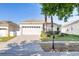 Charming single-story home with manicured lawn, paved driveway, and attached two-car garage at 217 Herring St, Davenport, FL 33897