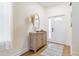 Bright foyer featuring a decorative mirror, a wooden console table, and a patterned rug on the hardwood floors at 217 Herring St, Davenport, FL 33897