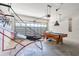 Spacious garage area featuring a pool table and basketball hoop, creating a versatile space at 217 Herring St, Davenport, FL 33897