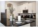Modern kitchen with stainless steel appliances, granite countertops, and white cabinetry at 217 Herring St, Davenport, FL 33897