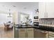 Modern kitchen featuring sleek countertops, stainless steel appliances, and an open view to the dining area at 217 Herring St, Davenport, FL 33897