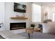 Bright living room featuring a modern fireplace, mounted TV, round wood table, and sheer curtains at 217 Herring St, Davenport, FL 33897