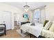 Comfortable main bedroom with ensuite bathroom, modern chandelier, and sunny window at 217 Herring St, Davenport, FL 33897