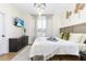 Bright main bedroom with a large window, stylish decor, and comfortable bedding at 217 Herring St, Davenport, FL 33897