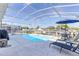 Relaxing screened-in pool area with lounge chairs and dining set for outdoor enjoyment at 217 Herring St, Davenport, FL 33897